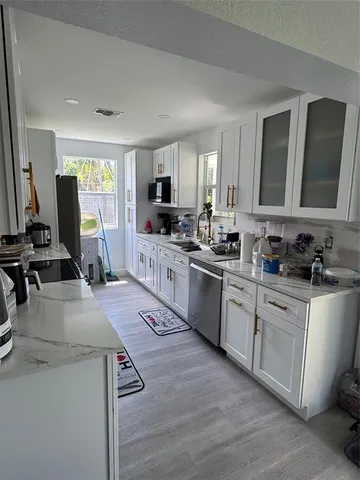a kitchen with a sink stove and refrigerator