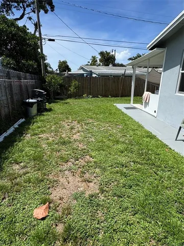 a view of a house with a yard and garage
