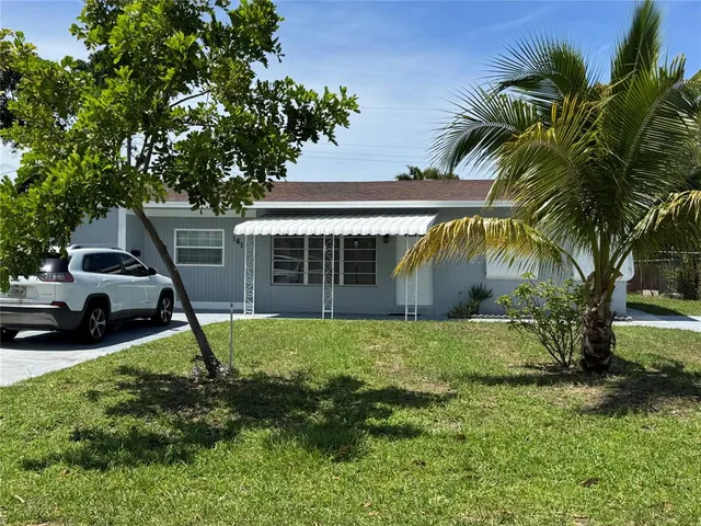 a house with green field in front of it