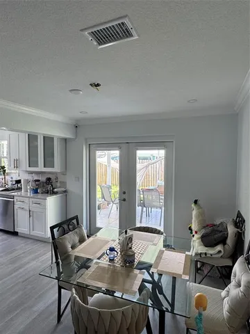 a view of a dining room with furniture and windows