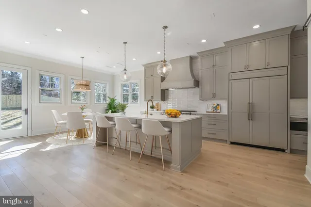 a kitchen with white cabinets and counter space