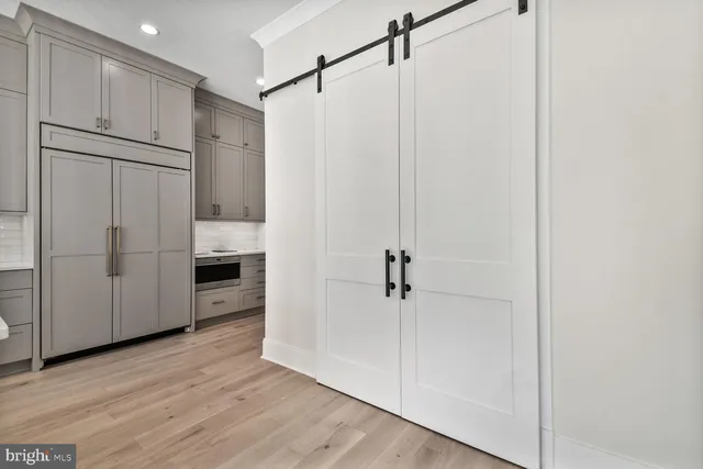 a view of a kitchen with a white cabinet and wooden floor