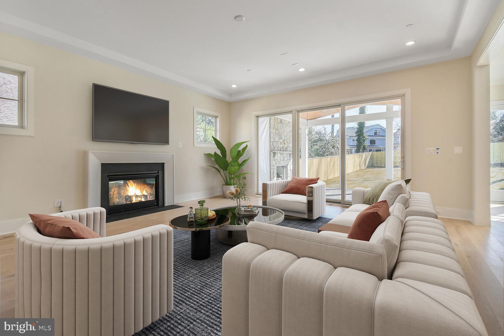 7819 Exeter Road Bethesda, MD 20814 - Photo 16 of 44 a living room with furniture a large window and a fireplace