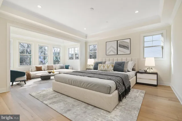 a bedroom with a large bed couch and a window