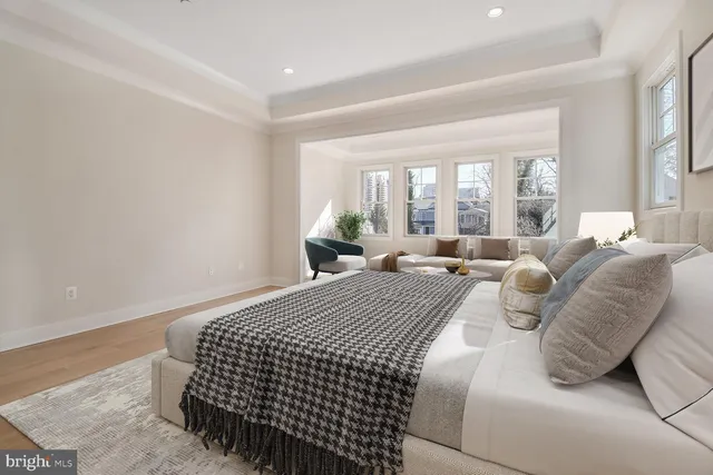 a bedroom with bed and a large window