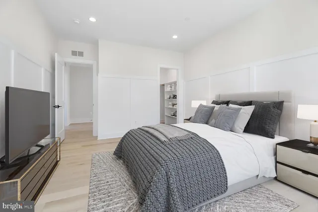 a bedroom with a bed and a flat screen tv