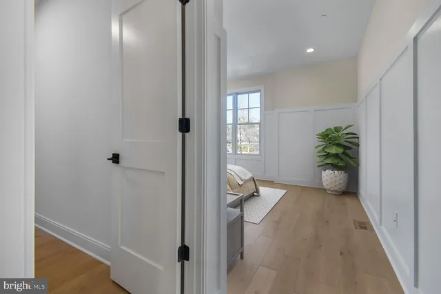 a view of a hallway with closet and wooden floor