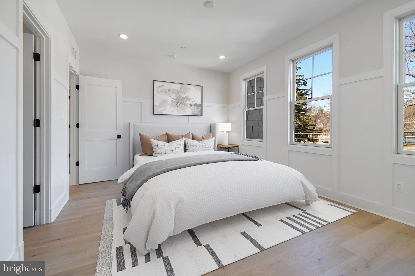 7819 Exeter Road Bethesda, MD 20814 - Photo 34 of 44 a bedroom with a bed and a painting on the wall