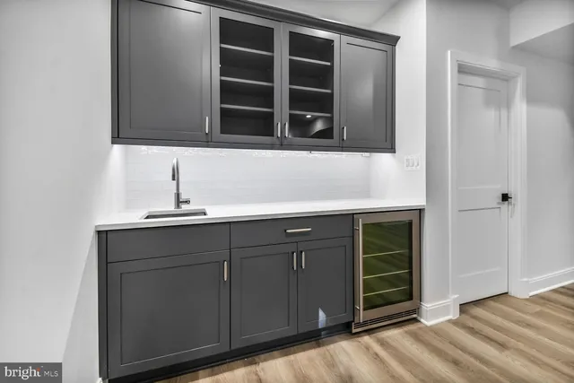 a kitchen with a sink and a mirror