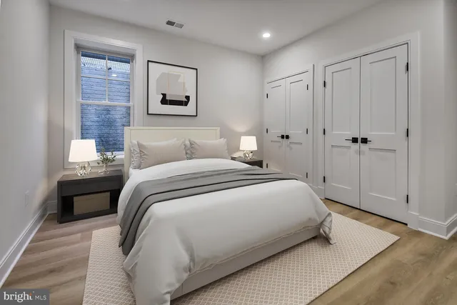 a bedroom with a bed and a painting on the wall