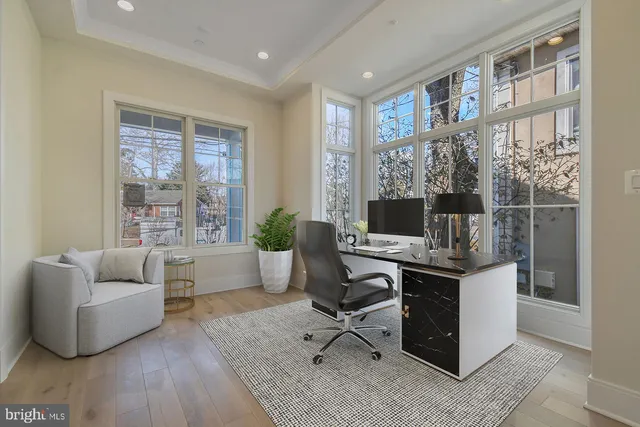 a view of a livingroom with workspace and a couch