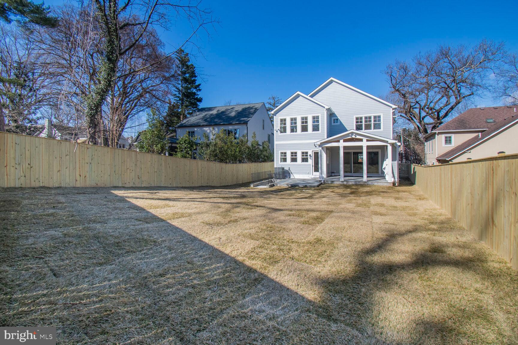 7819 Exeter Road Bethesda, MD 20814 - Photo 42 of 44 a front view of a house with a yard and garage