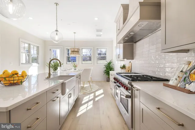 a kitchen with a stove a sink and a refrigerator