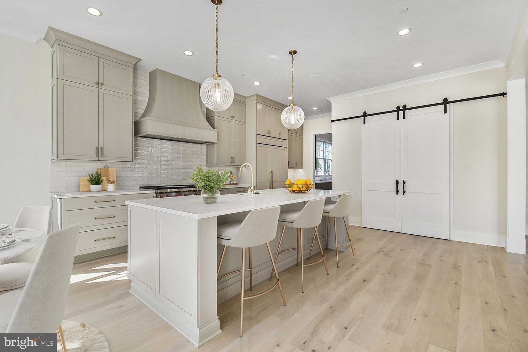 7819 Exeter Road Bethesda, MD 20814 - Photo 10 of 44 a large kitchen with a sink stainless steel appliances and cabinets