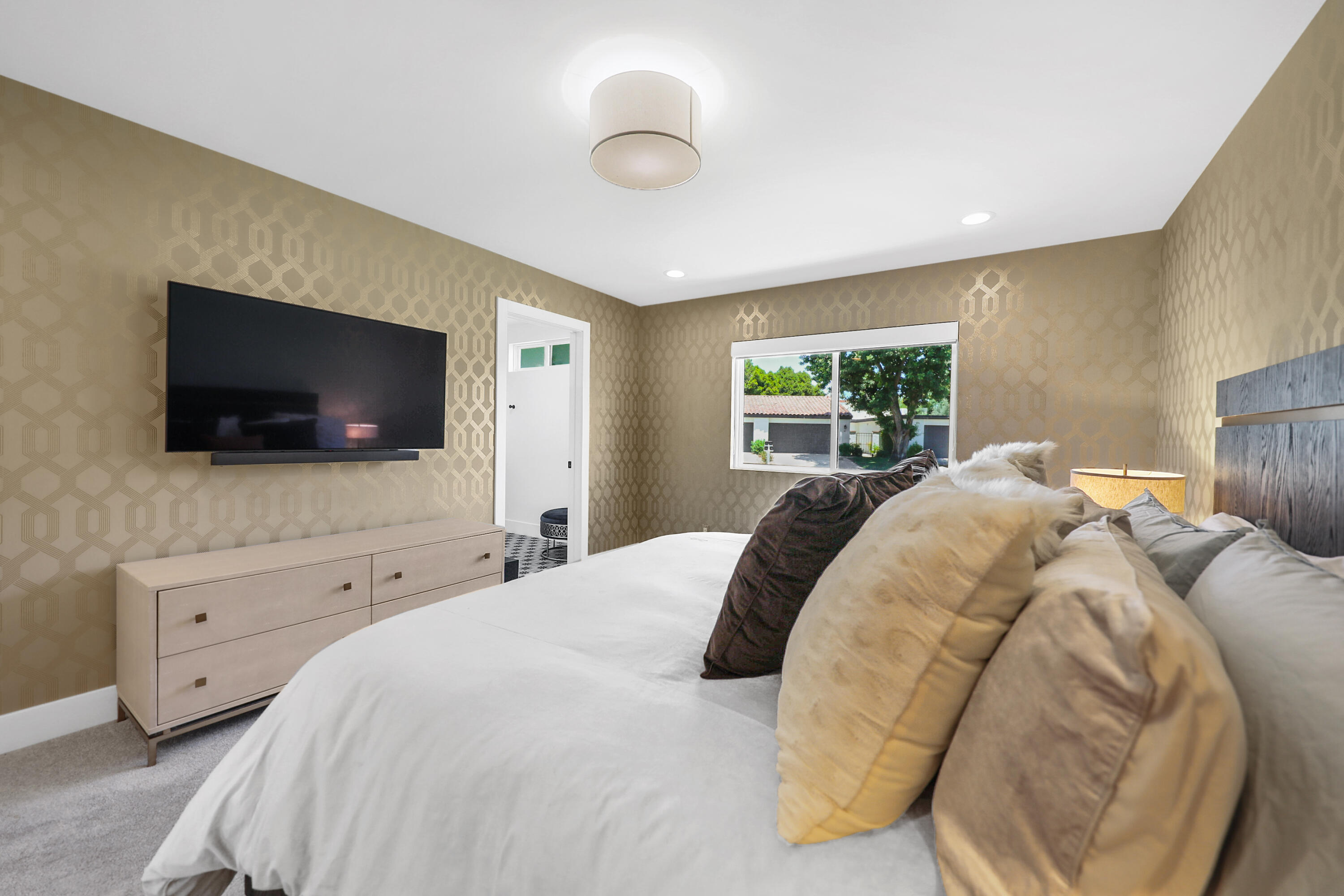 24 Leon Way Rancho Mirage, CA 92270 - Photo 16 of 30 a bedroom with a bed and a flat screen tv