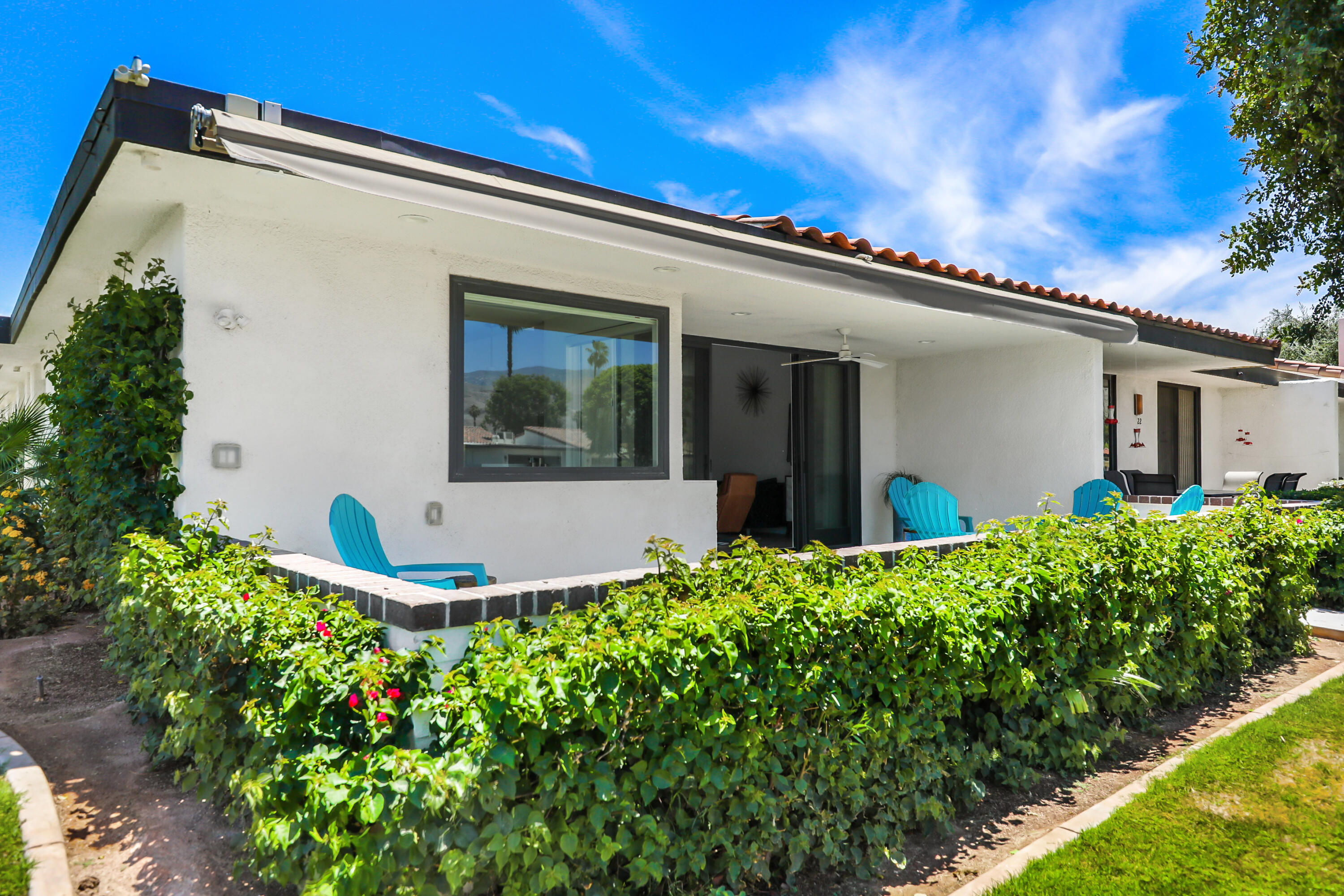 24 Leon Way Rancho Mirage, CA 92270 - Photo 22 of 30 a view of a house with a small yard and a garden