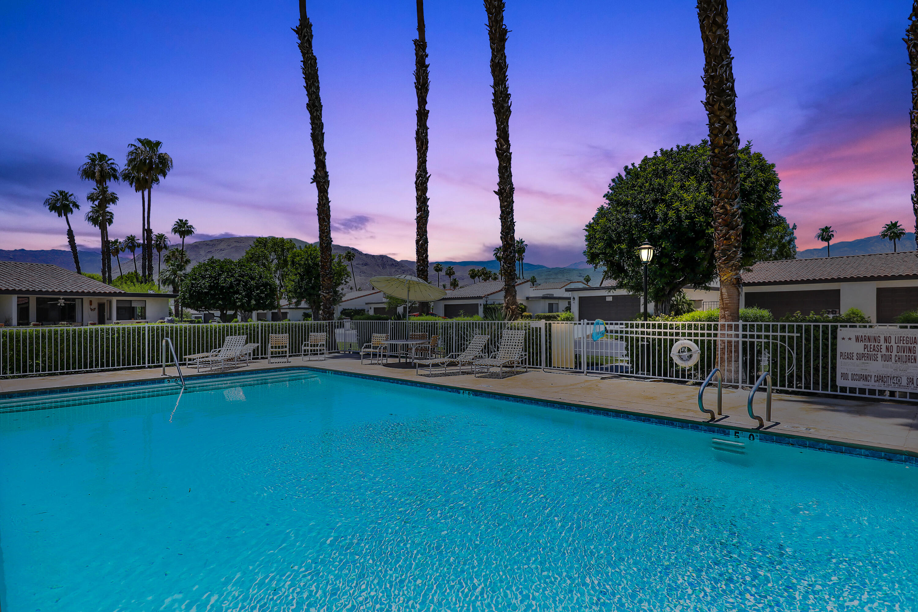 24 Leon Way Rancho Mirage, CA 92270 - Photo 25 of 30 a view of a swimming pool with a table and chairs