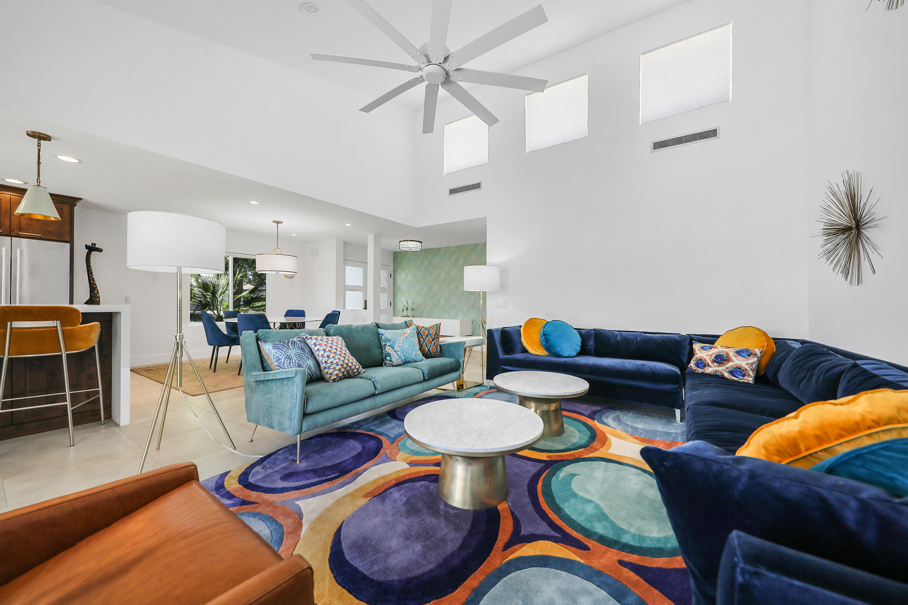 24 Leon Way Rancho Mirage, CA 92270 - Photo 4 of 30 a living room with furniture a rug and a chandelier