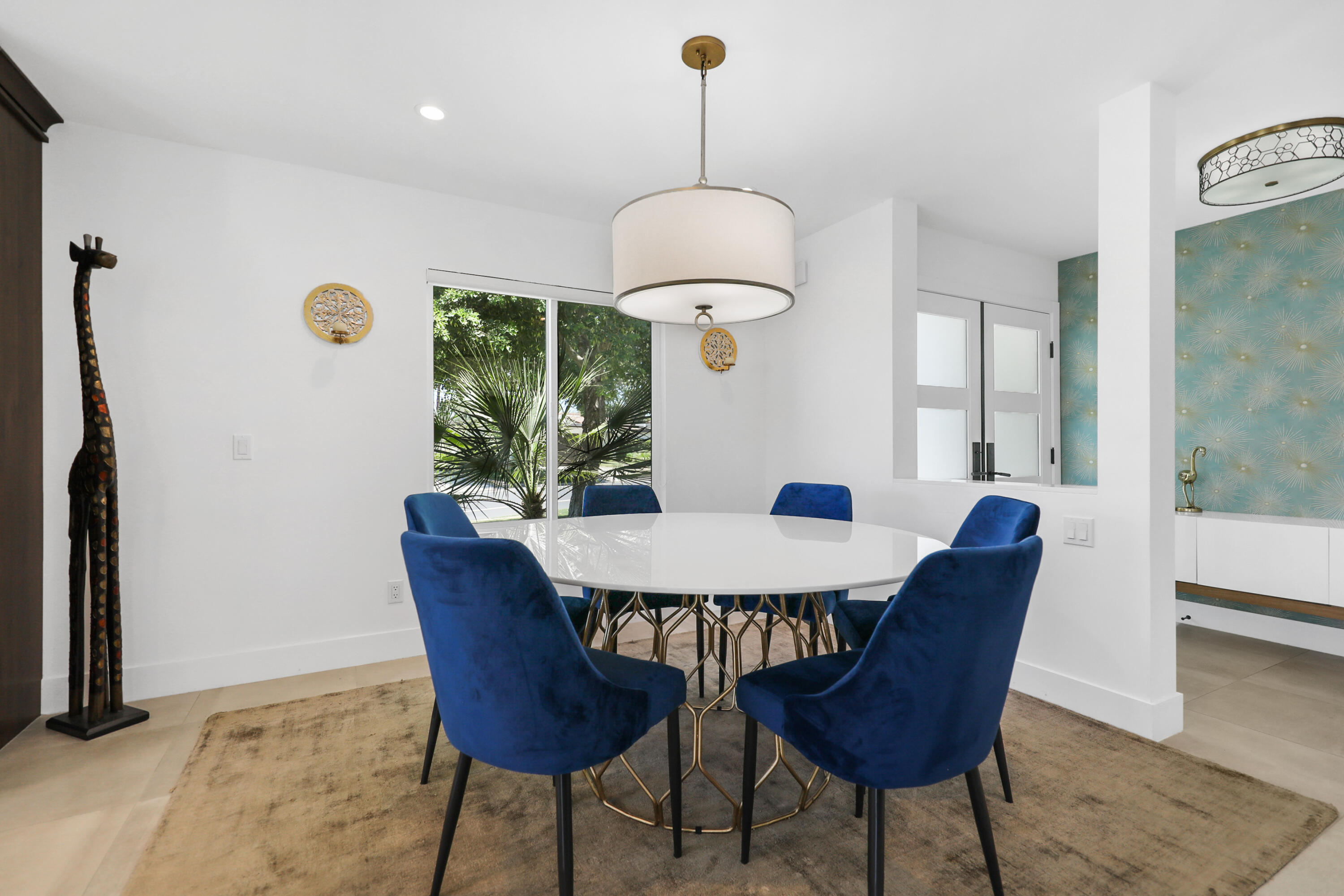 24 Leon Way Rancho Mirage, CA 92270 - Photo 6 of 30 a dining room with furniture a window and a chandelier