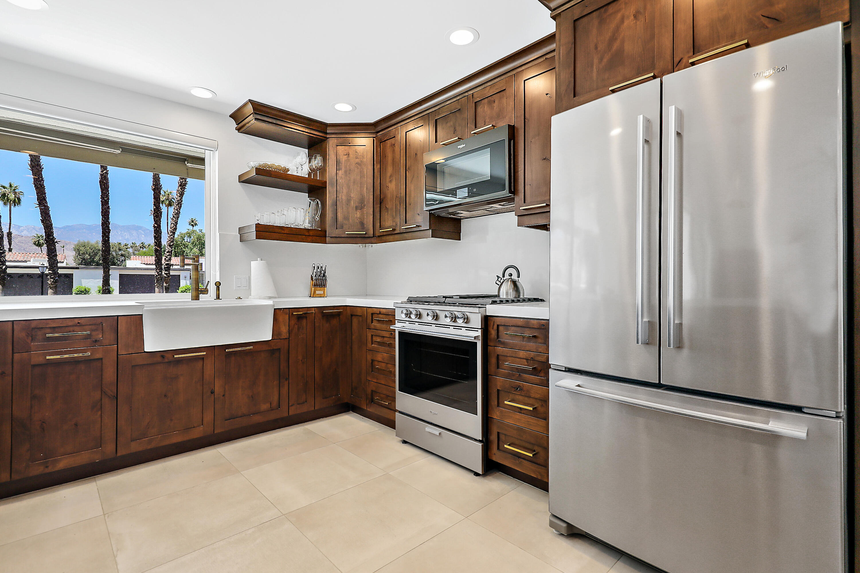 24 Leon Way Rancho Mirage, CA 92270 - Photo 9 of 30 a kitchen with stainless steel appliances a refrigerator and a sink