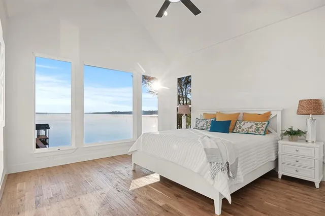 a bedroom with a bed and large window