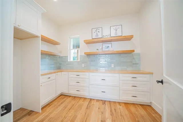 a kitchen with a cabinets and wooden floor