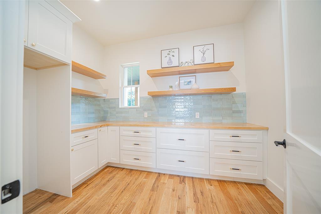 646 North Private Road Leesburg, TX 75451 - Photo 12 of 40 a kitchen with a cabinets and wooden floor