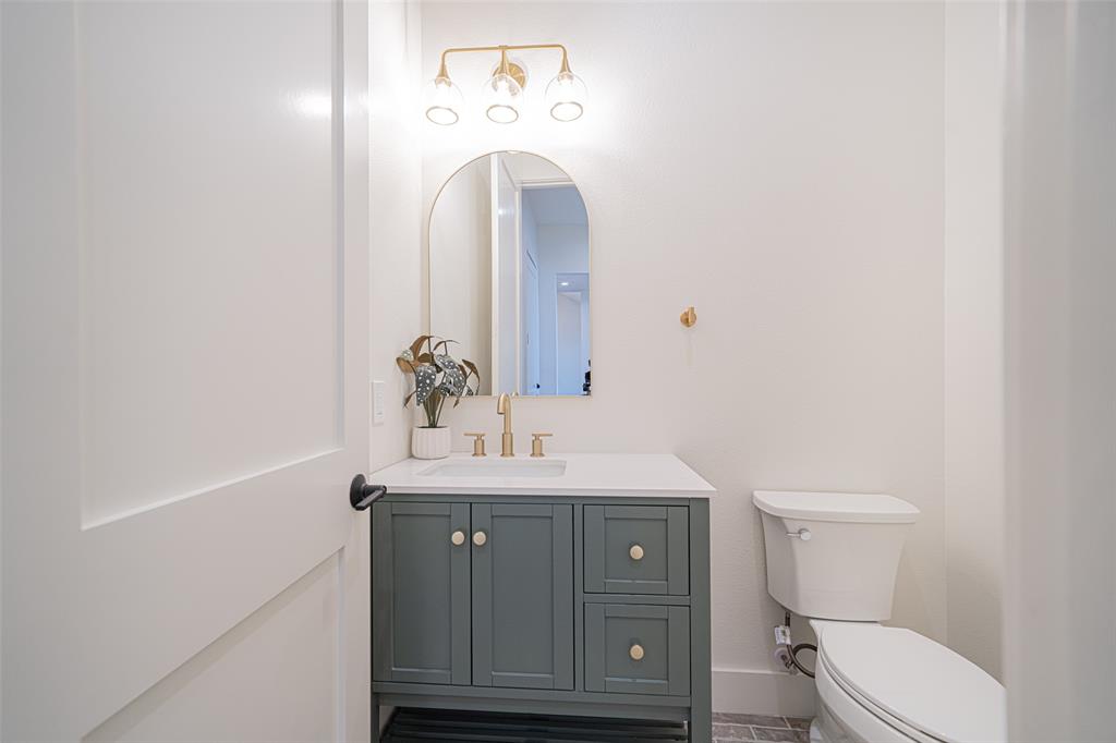 646 North Private Road Leesburg, TX 75451 - Photo 21 of 40 a bathroom with a toilet a sink and mirror