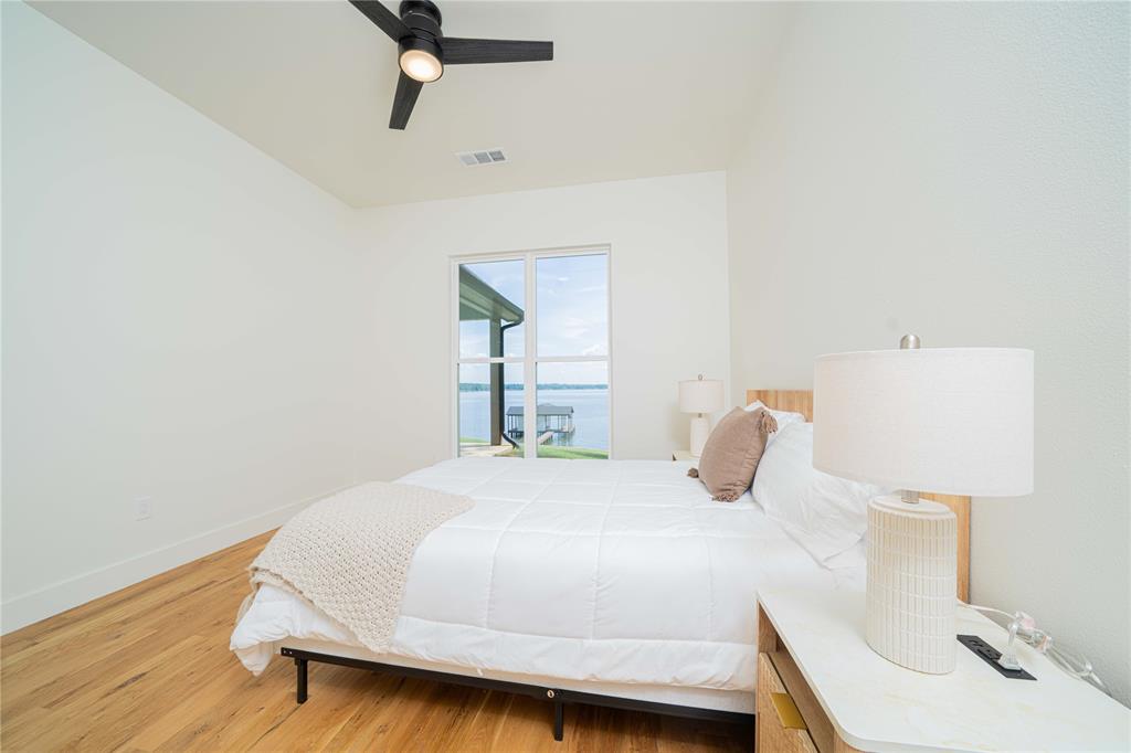 646 North Private Road Leesburg, TX 75451 - Photo 22 of 40 a bedroom with a bed and wooden floor