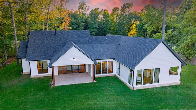 a aerial view of a house with a yard and deck