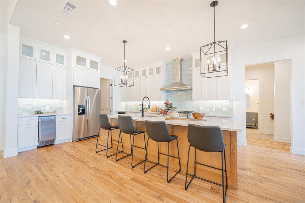 646 North Private Road Leesburg, TX 75451 - Photo 10 of 40 a kitchen with stainless steel appliances kitchen island granite countertop a dining table chairs and white cabinets