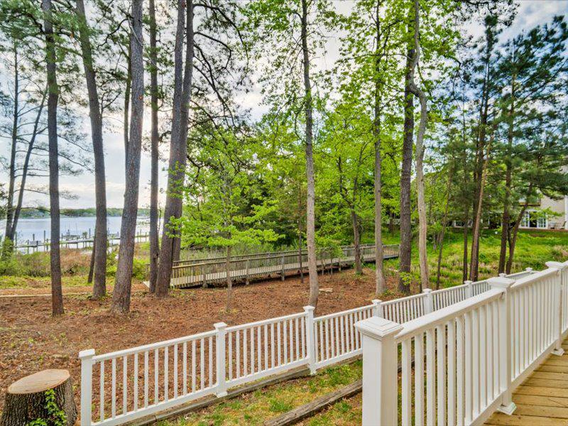 14240 Foxhall Road, Unit 15 Solomons, MD 20629 - Photo 4 of 7 a view of a wooden deck next to a yard