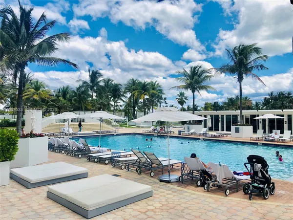 a view of a patio with swimming pool table and chairs