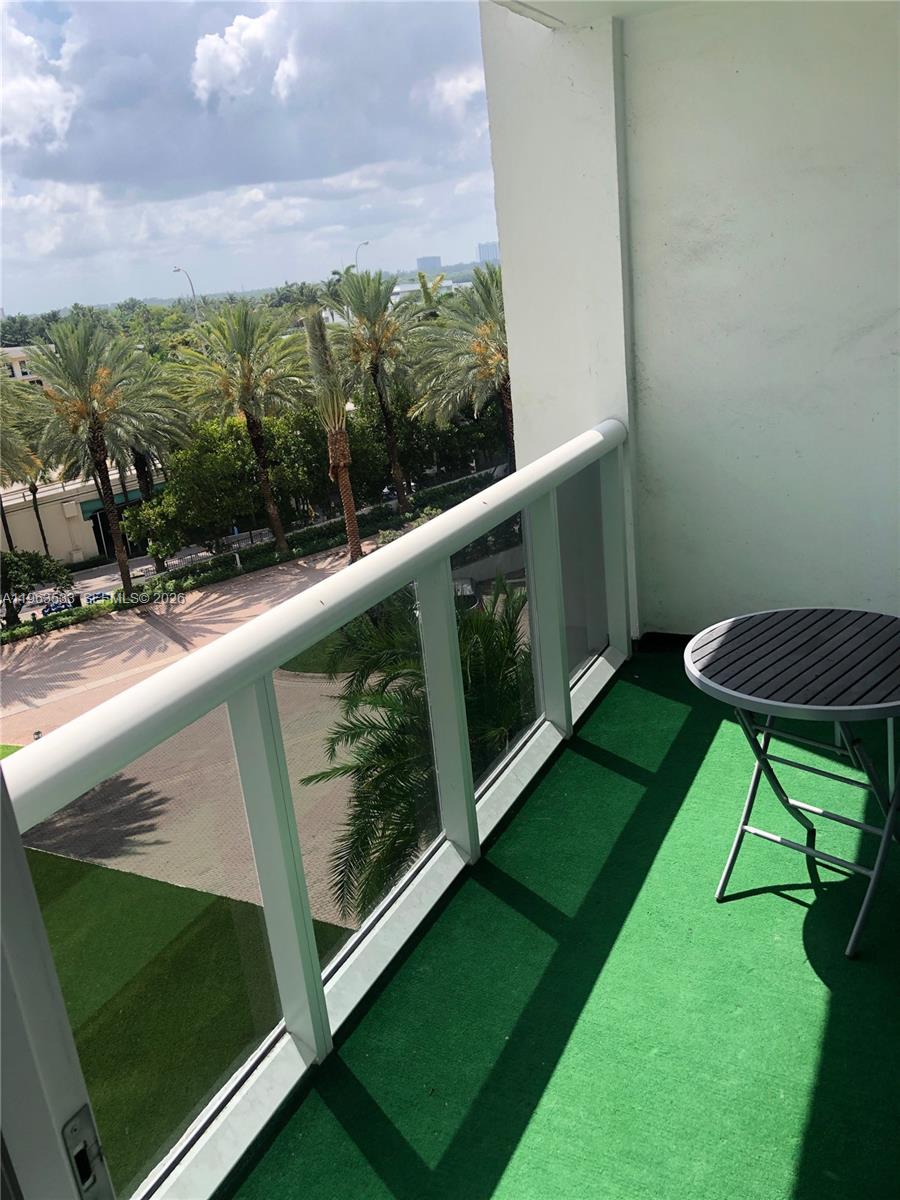 10275 Collins Avenue, Unit 427 Bal Harbour, FL 33154 - Photo 9 of 21 a view of a two chairs in the garden