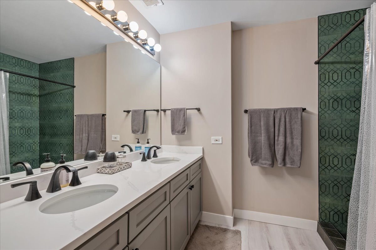 811 West 15th Place, Unit 708 Chicago, IL 60608 - Photo 9 of 26 a bathroom with a double vanity sink mirror and shower