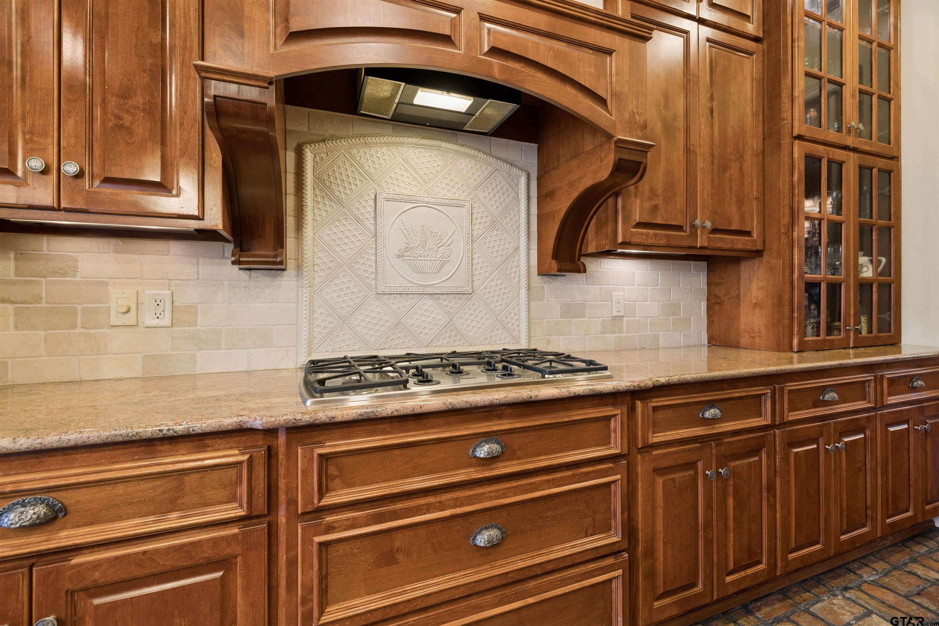 15120 Big Oak Bay Road Tyler, TX 75707 - Photo 4 of 34 a stove top oven sitting inside of a kitchen