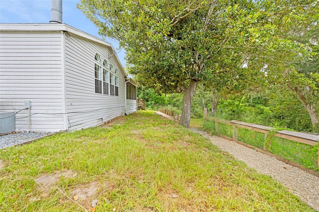 33320 Larkin Road Dade City, FL 33523 - Photo 50 of 60 a view of a backyard with a small cabin