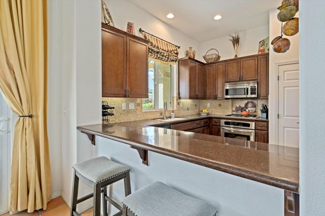 a kitchen with stainless steel appliances a sink and a refrigerator