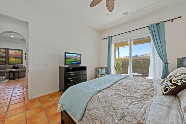 a bedroom with a bed and a television