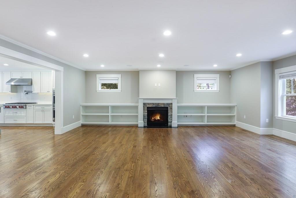 28 Fells Road Winchester, MA 01890 - Photo 11 of 42 a view of empty room with wooden floor and fireplace