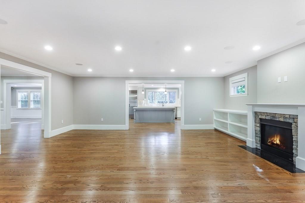 28 Fells Road Winchester, MA 01890 - Photo 12 of 42 a view of an empty room with wooden floor fireplace and a window