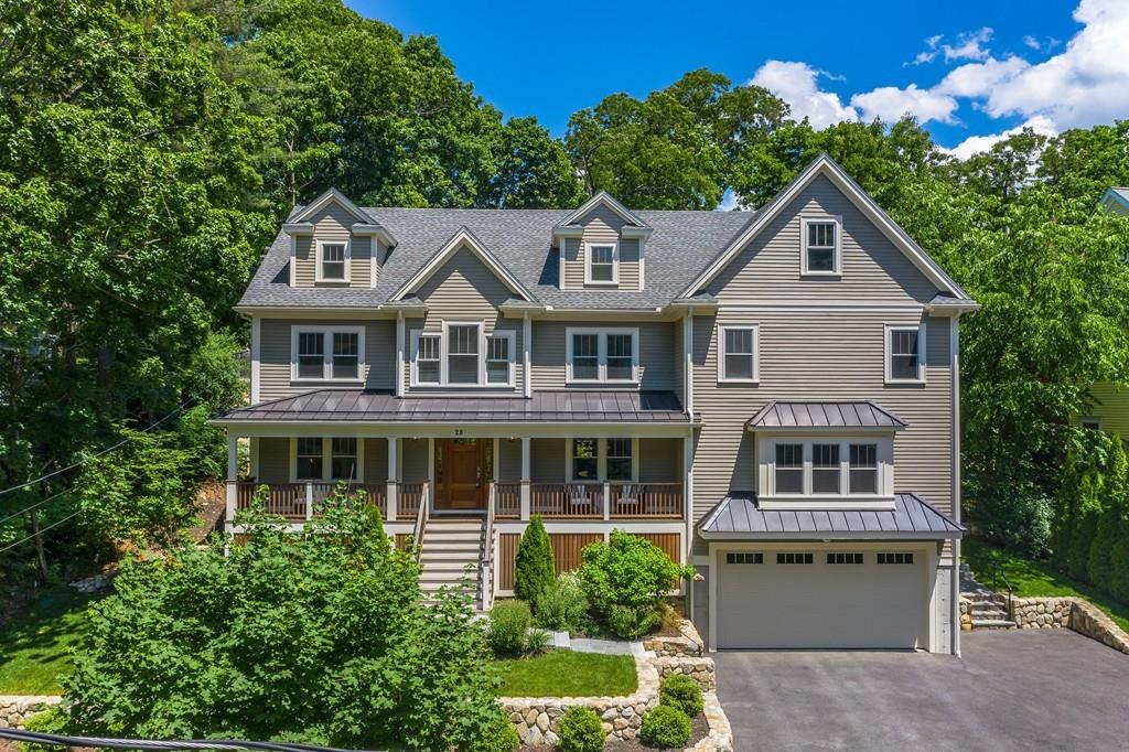 28 Fells Road Winchester, MA 01890 - Photo 2 of 42 a front view of a house with a yard and garage