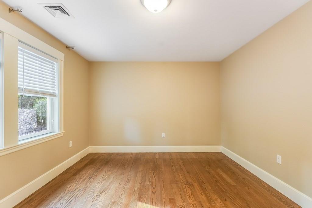28 Fells Road Winchester, MA 01890 - Photo 26 of 42 a view of an empty room with wooden floor and a window