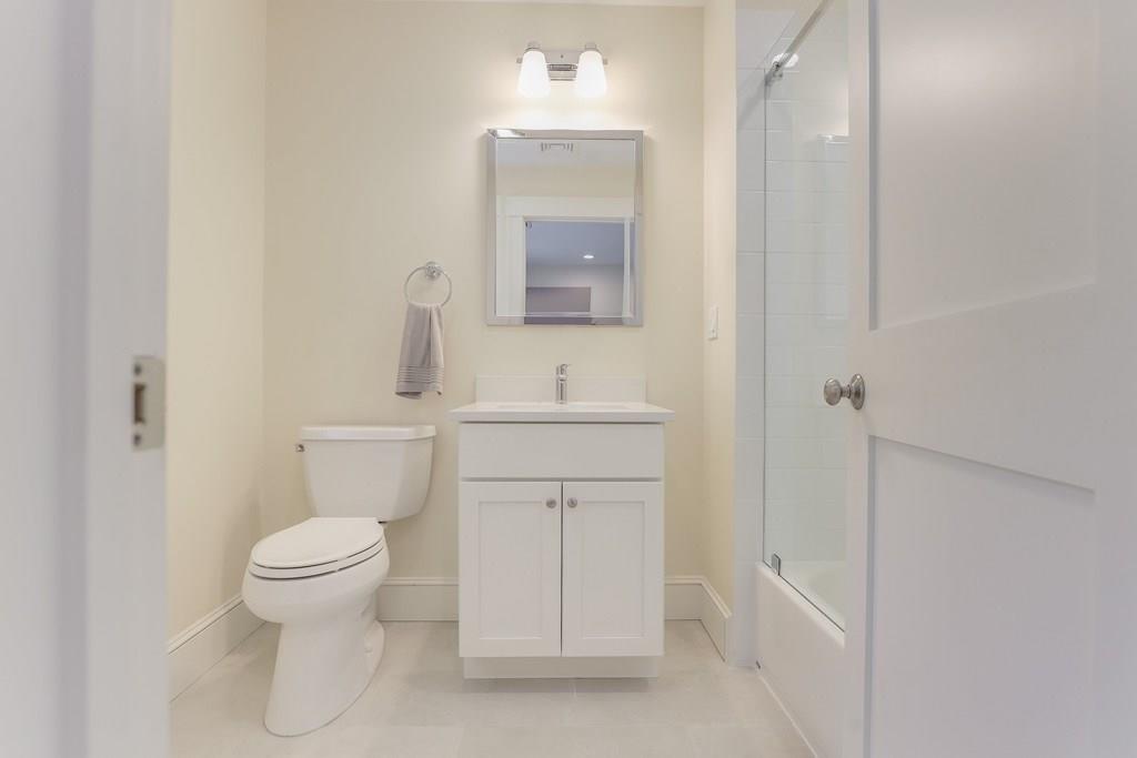 28 Fells Road Winchester, MA 01890 - Photo 28 of 42 a bathroom with a sink toilet vanity and mirror
