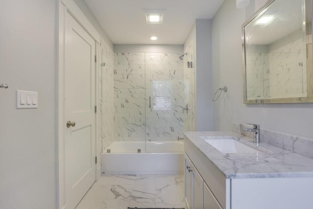 28 Fells Road Winchester, MA 01890 - Photo 29 of 42 a bathroom with a granite countertop sink a toilet and shower