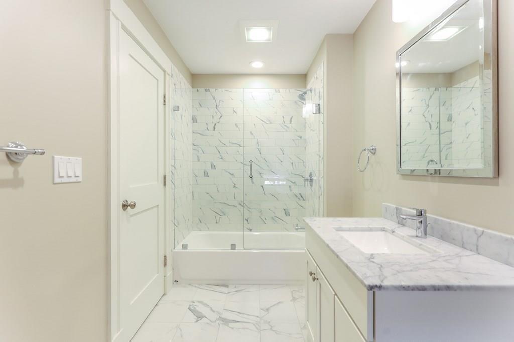 28 Fells Road Winchester, MA 01890 - Photo 32 of 42 a bathroom with a granite countertop sink a toilet and shower