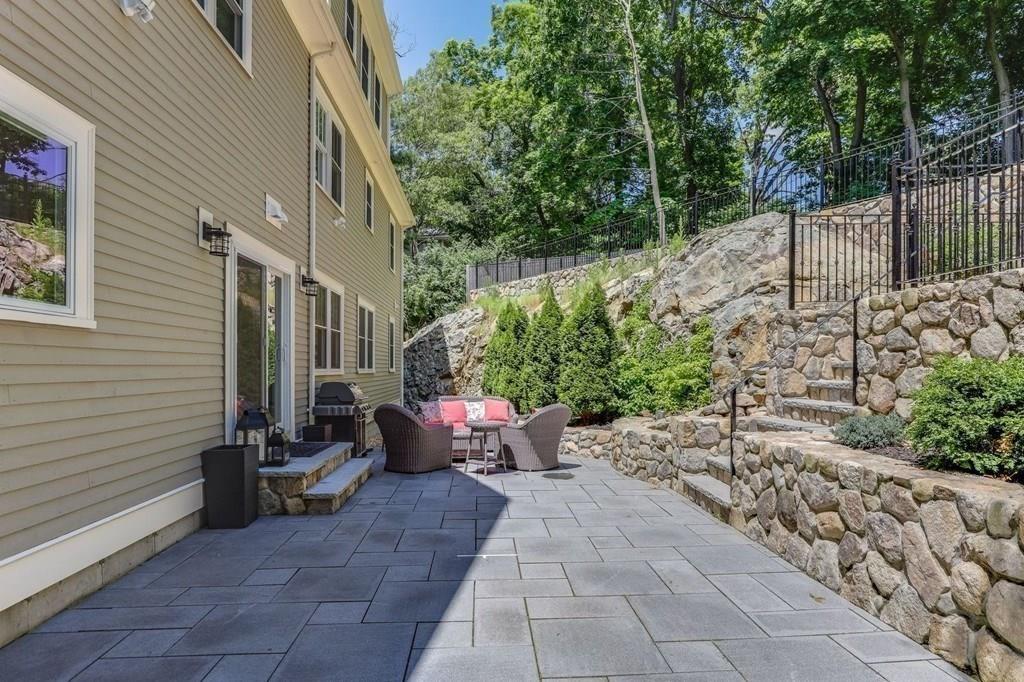 28 Fells Road Winchester, MA 01890 - Photo 39 of 42 a view of a patio with table and chairs and potted plants