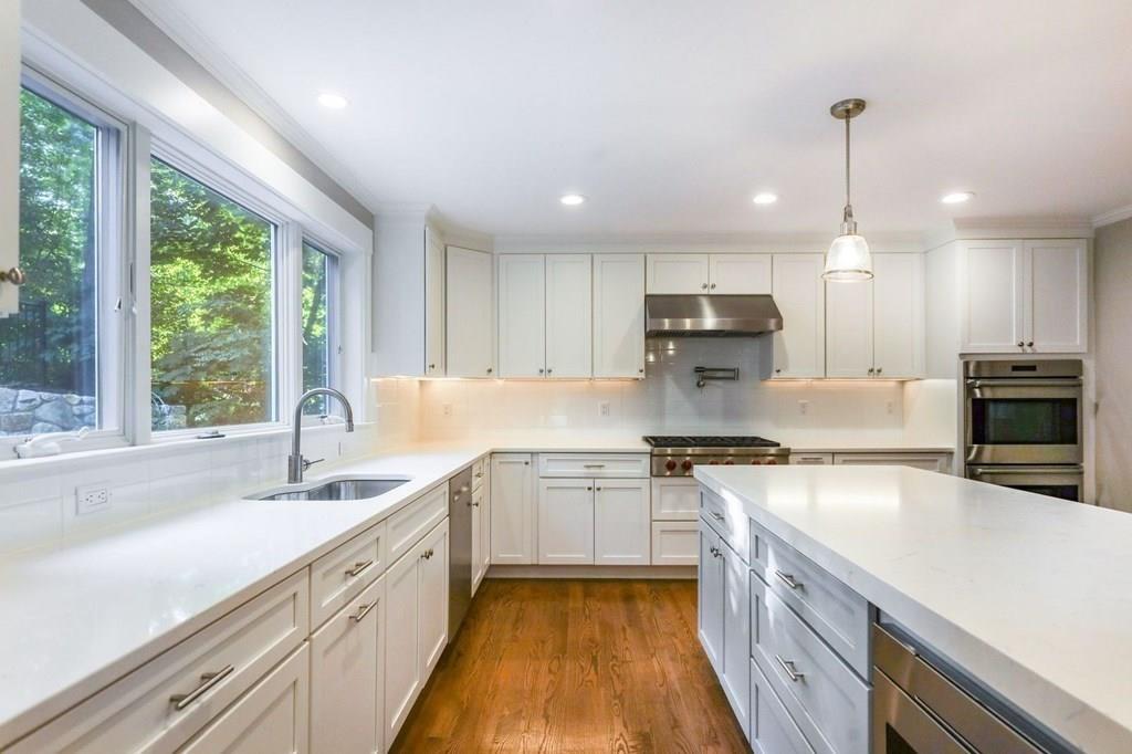 28 Fells Road Winchester, MA 01890 - Photo 8 of 42 a kitchen with granite countertop a sink a counter top space stainless steel appliances and a large window