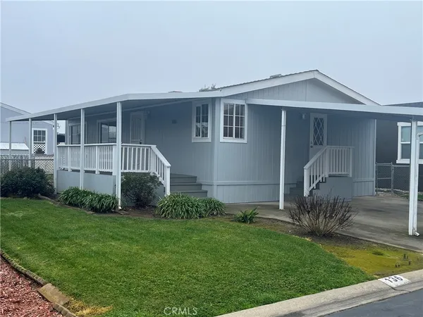 a view of house with backyard and garden