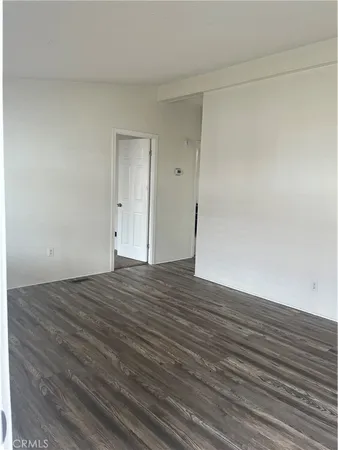 a view of an empty room and wooden floor